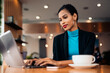© Santi Nunez/Stocksy - Afro woman using laptop in the restaurant