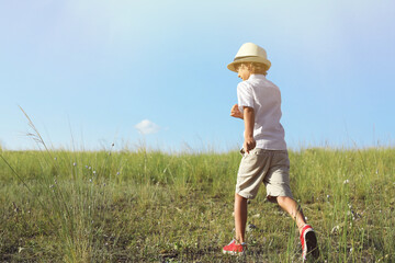 Sticker - Cute little boy wearing stylish hat outdoors, space for text. Child spending time in nature