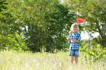 Sticker - Cute little boy with butterfly net outdoors, space for text. Child spending time in nature