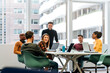 © David Prado/Stocksy - Coworkers having meeting in conference room