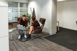 © David Prado/Stocksy - Content business partners chatting while working together with laptop at office