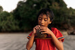 © Santi Nunez/Stocksy - Young latin girl eating a coconut.