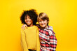 © Santi Nunez/Stocksy - Two children looking at the camera in studio.