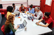 © Santi Nunez/Stocksy - Business group at a workshop in the office