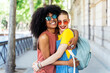 © Santi Nunez/Stocksy - Beautiful lesbian couple having fun at the street