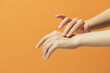 © Maki Company Limited/Stocksy - Young woman applies serum on her hands