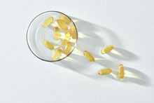 Bunch Of Omega 3 Fish Liver Oil Capsules In Small Glass Bowl