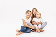 © Derek Henthorn/Westend61 - Female toddler sitting on elder sister's lap against white background in studio