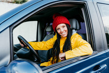 Smiling Woman Driving Car During Road Trip