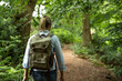 © PETE  MULLER/Westend61 - Senior woman walking with backpack in forest