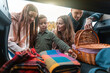© William Perugini/Westend61 - Family picking up picnic stuff from car trunk