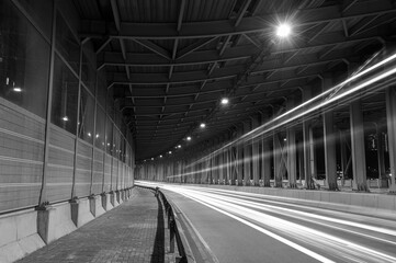 Poster - light trails and head lights of traffic in tunnel. Transportation background