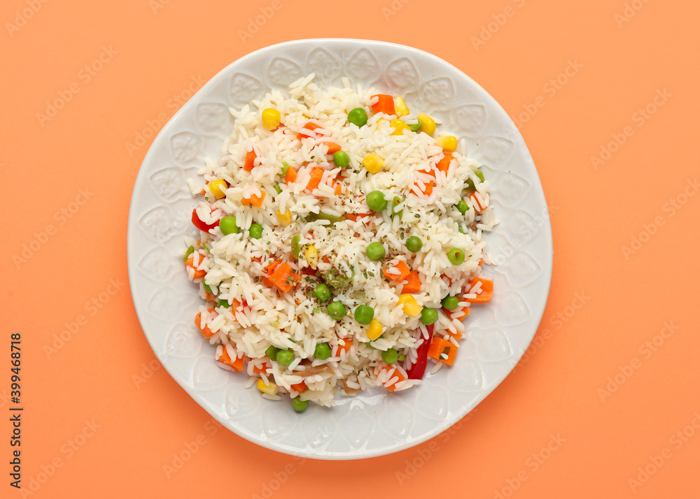 Plate with tasty pilaf on color background