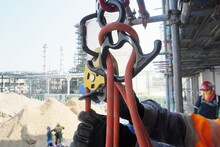 Rope Access Industry Worker Attaching, Tie, Secure A White Rope With Figure Of Knot Into Aluminum Safety Harness Loop Equipment And Up Lock Pulley For Rope Grab.