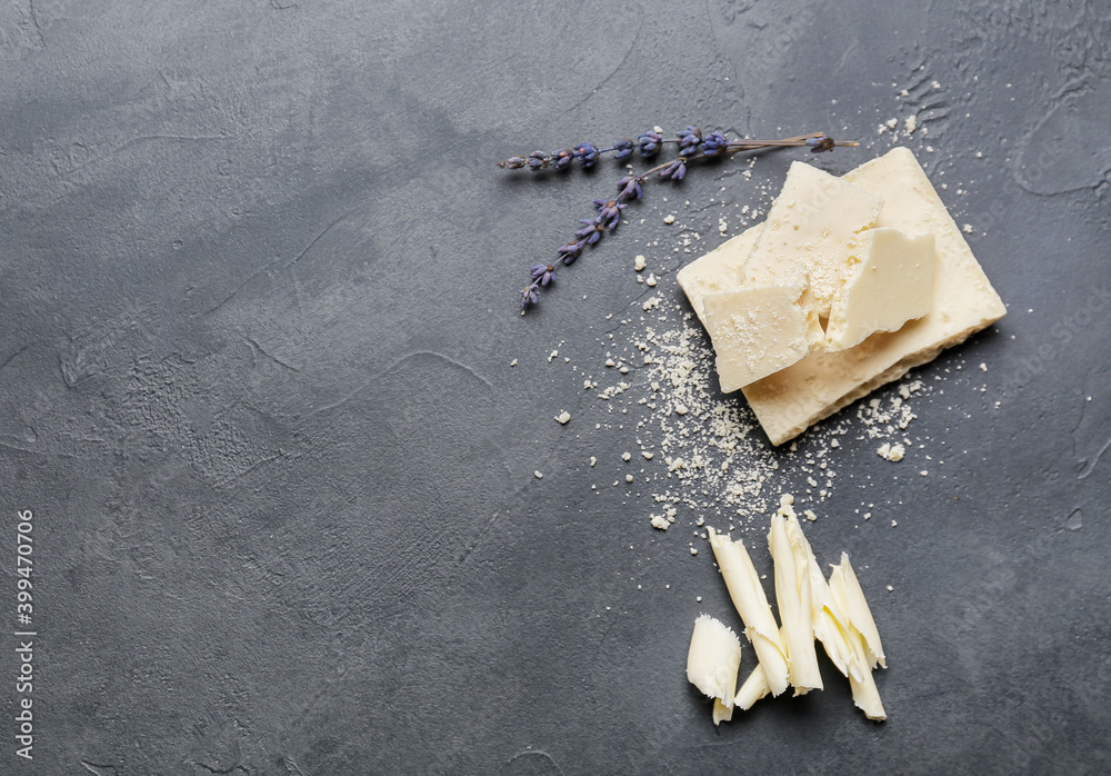Chocolate shavings with lavender flowers on dark background
