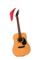 Guitar with Santa Claus hat on white background