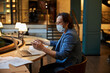 © Svitlana - Mindful worker using protective mask while working in public area