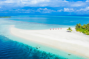 Aerial photo of beautiful Maldives paradise tropical beach. Amazing view, blue turquoise lagoon water, palm trees and white sandy beach. Luxury travel vacation destination. Sunny aerial landscape
