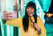 © Alessandro Biascioli - Asian girl taking selfie with mobile smartphone in amusement park - Youth social millennial people and technology trends concept