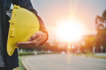 Businessman holding hard hat on site construction building estate