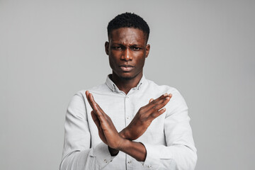 Wall Mural - Displeased young african american man in white shirt