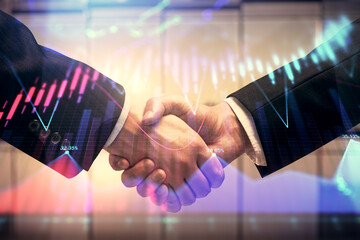 Double exposure of forex graph hologram and handshake of two men. Stock market concept.