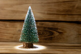 Fototapeta Lawenda - Artificial Christmas tree on a wooden background, shallow depth of field.