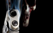 3d rendering of a ghost gun with a smoking pistol in focus up front and a red skull behind out of focus