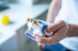 © JacZia - Giving someone a cigarette. Pack of cigarettes in a male hand. Smoking habit.