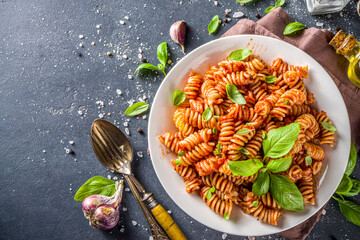 Fusilli pasta with tomato sauce and basil