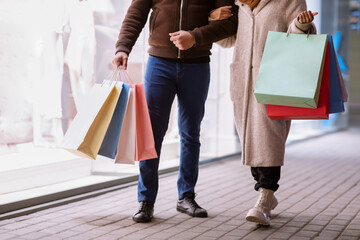 Unrecognizable afro couple walking with shopping bags