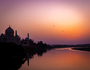  sunset over the river beside taj mahal 