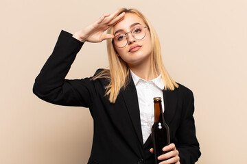 Wall Mural - young blonde woman greeting the camera with a military salute in an act of honor and patriotism, showing respect