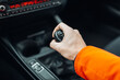Man's hand switches manual transmission closeup. Manual gearbox handle stick at the car. Man is driving 
