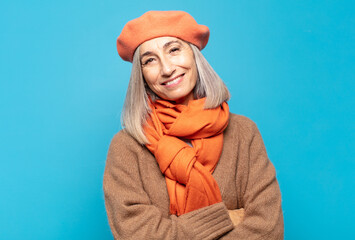 Wall Mural - middle age woman laughing happily with arms crossed, with a relaxed, positive and satisfied pose