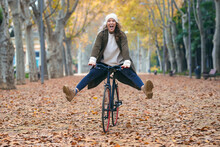 Pretty Funny Woman With A Vintage Bike Enjoying Time While Cycling Through The Park In Autumn.