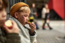 Outcast Boy Eating Food Given By Strangers In Street, Poor Child Is Happy To Eat Something