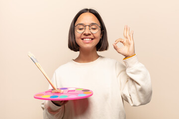 Sticker - young hispanic woman shouting aggressively with annoyed, frustrated, angry look and tight fists, feeling furious