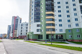 Fototapeta Miasto - view of residential area with multi-storey skyscraper building and and improved courtyard area