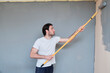 © Teodor Lazarev - Young handsome man painting his walls