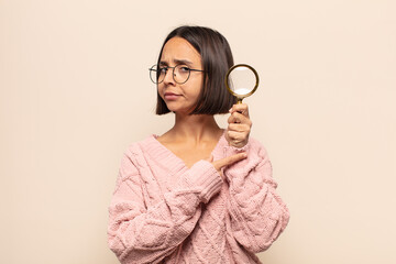 Canvas Print - young hispanic woman looking impatient and angry, pointing at watch, asking for punctuality, wants to be on time