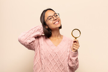 Canvas Print - young hispanic woman smiling and feeling relaxed, satisfied and carefree, laughing positively and chilling