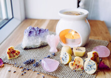 Homemade Mini Wax Melts In Aromatherapy Lamp Diffuser At Home Interior With Rose Quartz Crystal Hearts And Angel For Decoration On Wooden Window Sill On Winter. Seasonal Spiritual Zen Concept.