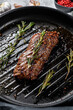 Cooked top blade, Denver steak in a pan. Marble meat beef. Gray background. Top view