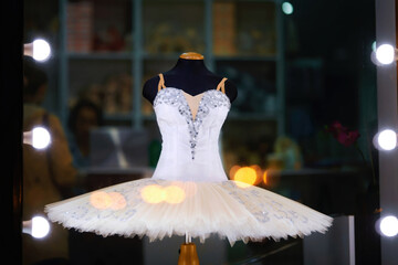 White ballet tutu on display in ballet store accessory. Showcase of ballet accessories shop, professional tutu and costume