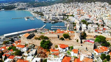 Canvas Print - Aerial view of Kavala, a lot of buildings, Aegean sea coast, sea port, ancient fort, green hills in the distance, Greece