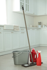 Wall Mural - Mop, detergents and plastic bucket in kitchen. Cleaning supplies