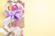 © Kamran - front view little presents on light-yellow desk new year xmas gift color photo holiday