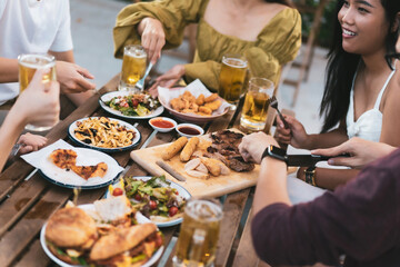 Group holiday party of asian people Eating dinner and drinking beer at home