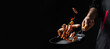 © Надія Коваль - Chef hands cooking shrimps or prawn in pan on black background. banner, menu, recipe, place for text